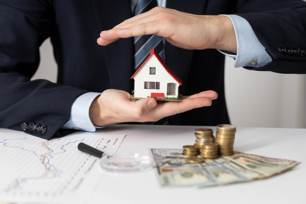 A person holding a house in their hands