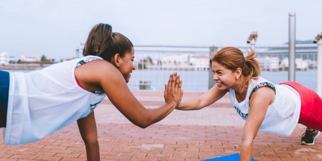 Two girls giving each other a high five.